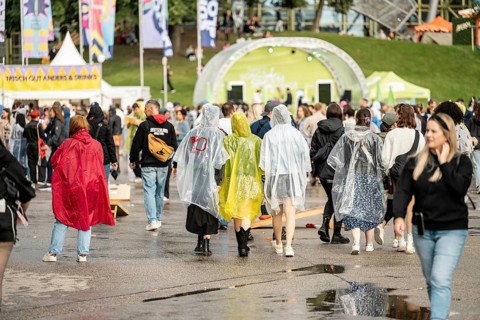 Festival visitors with rain capes at the Superbloom Festival, Day 1 in the Olympic Park, Munich,