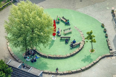 Aerial view, Peace Village International, resting place with benches and shady tree, non-profit