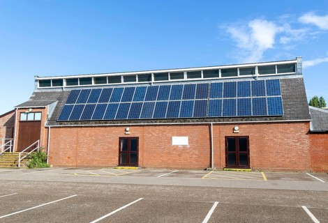 Solar panels on roof of Woodbridge Community Hall, community centre building, Woodbridge, Suffolk,