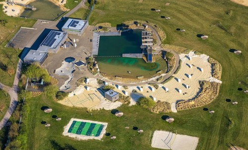 Aerial view, natural swimming pool Olfen outdoor pool and sandy beach and water playground,