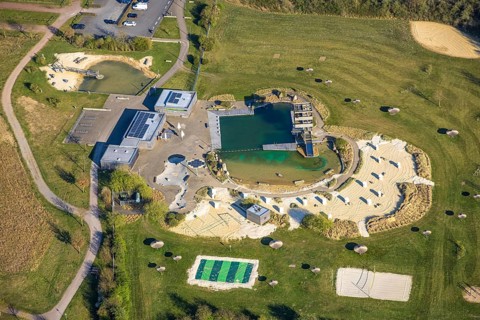 Aerial view, natural swimming pool Olfen outdoor pool and sandy beach and water playground,