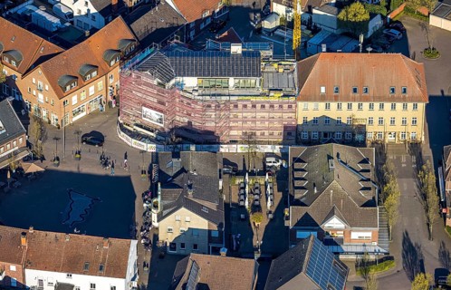Aerial view, town hall and new building construction site with facade cladding, market place, Olfen