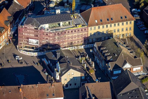 Aerial view, town hall and new building construction site with facade cladding, market place, Olfen