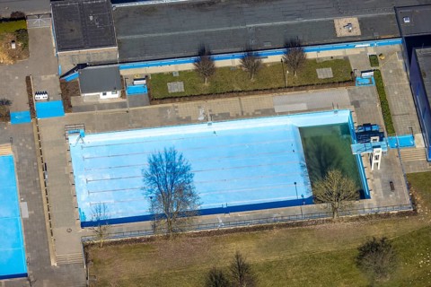 Aerial view, outdoor and indoor swimming pool, tree reflected in the pool, Meschede town, Meschede,
