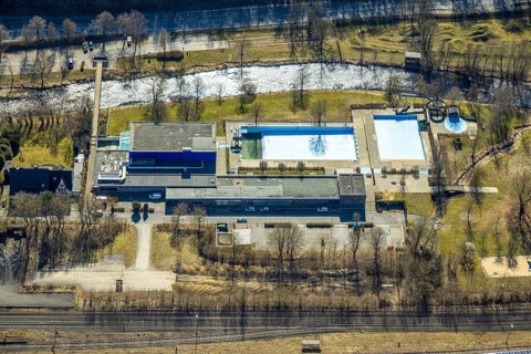 Aerial view, outdoor and indoor swimming pool, tree reflected in the pool, Meschede town, Meschede,