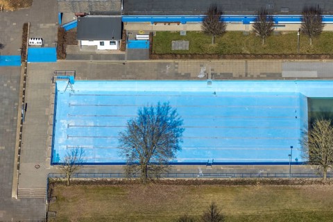Aerial view, outdoor and indoor swimming pool, tree reflected in the pool, Meschede town, Meschede,