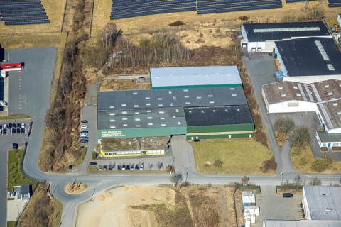 Aerial view, Enste industrial estate with citizen solar park on the A46 motorway, bush KG plant,