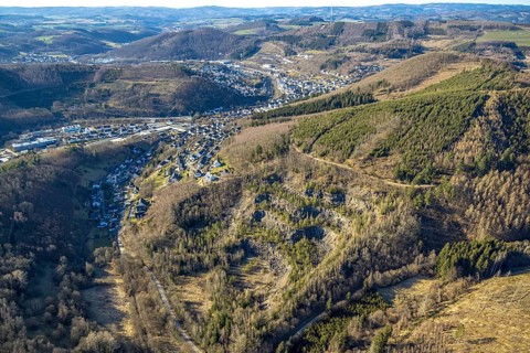 Aerial view, Faulebutter Siepen quarry, residential area hilly landscape and forest area with