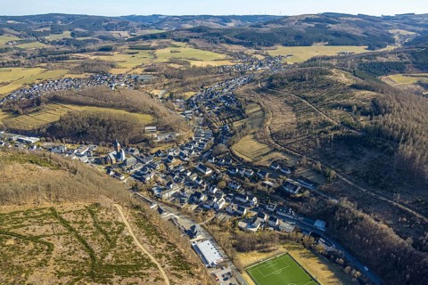 Aerial view, residential area local view, wooded area hilly landscape with forest damage, Church of