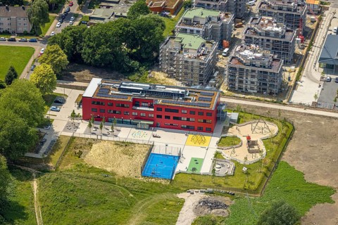 Aerial view, community primary school Schule am Schloss with red facade, roof with solar panels,