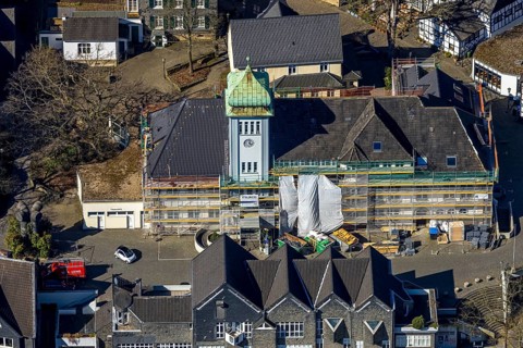 Aerial view, town hall in the old town centre construction site with renovation and covered house