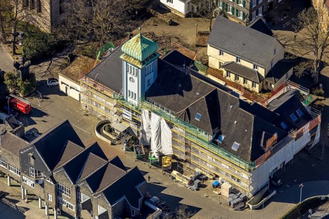 Aerial view, town hall in the old town centre construction site with renovation and covered house