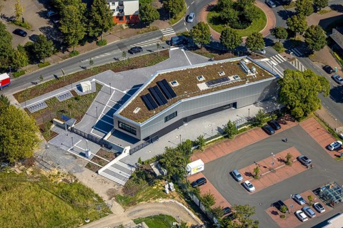 Aerial view, new integration house / health centre with café at the neighbourhood square in the
