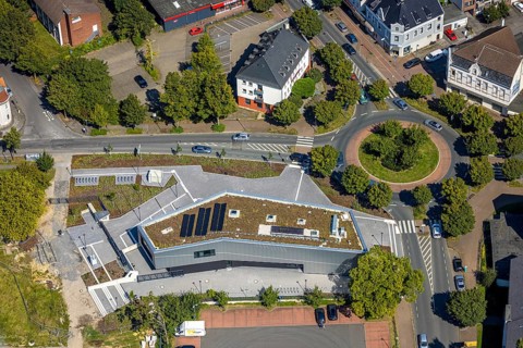 Aerial view, new integration house / health centre with café at the neighbourhood square in the