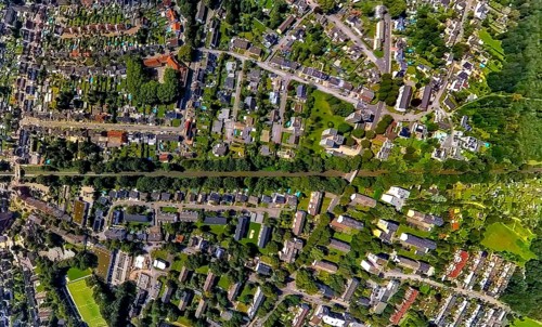 Aerial view, railway tracks and wooded railway line at Glückstraße residential area, earth globe,