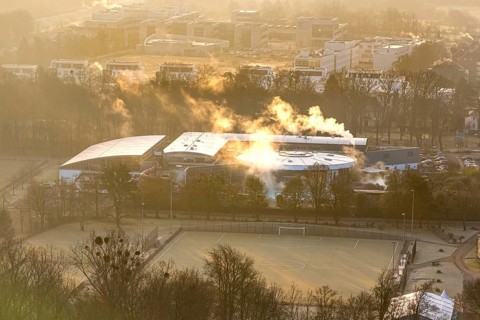 Aerial view, wintry Maximare adventure pool with indoor and outdoor pools with clouds of smoke, in
