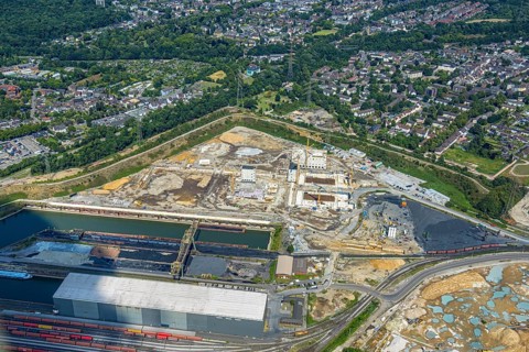 Aerial view, construction site with new electrical switchgear buildings for direct reduction plant