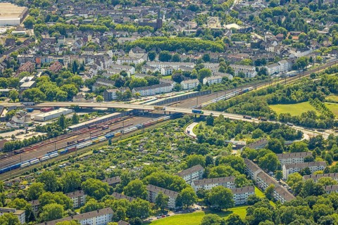 Aerial view, railway line with container site and bridge Friedrich-Ebert-Straße with curved road