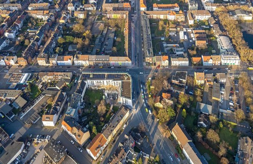 Aerial view, residential area and construction site with new residential building on the corner of
