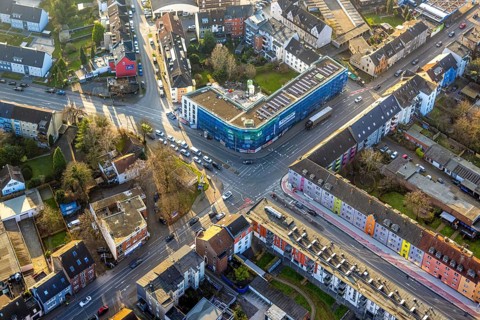 Aerial view, residential area and construction site with new residential building on the corner of