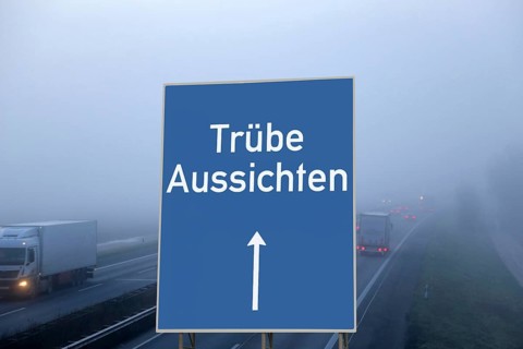(Photomontage) Motorway sign with the inscription TRÜBE AUSSICHTEN above a foggy motorway