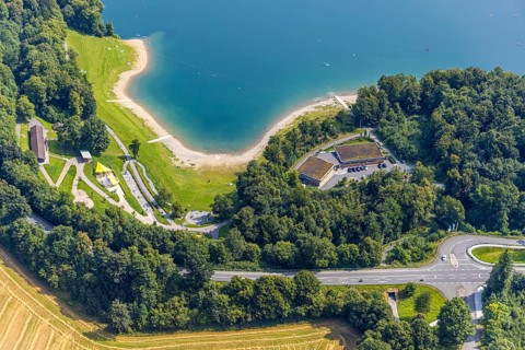 Aerial view, H1 am See Restaurant with green roof, sandy beach and adventure playground Piraten