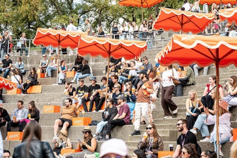 Visitors relax at the Aperol stand at the Superbloom Festival, Day 1 in the Olympic Park, Munich,
