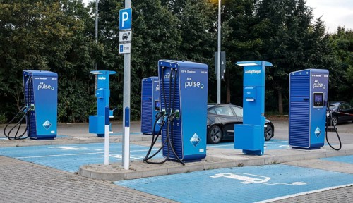 Charging stations with charging plugs at ARAl Pulse, Blankenfelde, 26/08/2025. A Tesla being