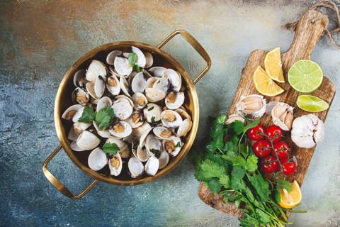 Cooking, vongole clams, in a pan with spices and white wine, top view, no people
