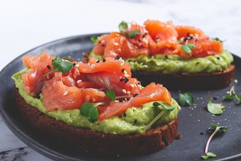 Breakfast, Sandwiches with smoked salmon and avocado, on dark rye bread, with microgreens, on a
