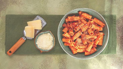 Rigatoni pasta, with meat sauce, and parmesan cheese, top view, homemade, no people