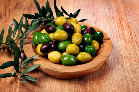 A mixture of olives, varieties of chalkidiki, Verdi giganti and Kalamata, in a bowl, top view, no