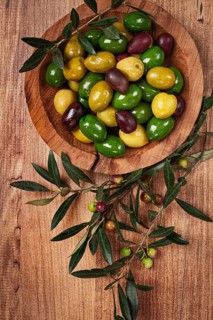 A mixture of olives, varieties of chalkidiki, Verdi giganti and Kalamata, in a bowl, top view, no