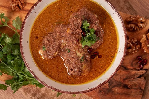 Fesenjan, an Iranian dish, stewed chicken, in a nut-pomegranate sauce, in a bowl, homemade, no