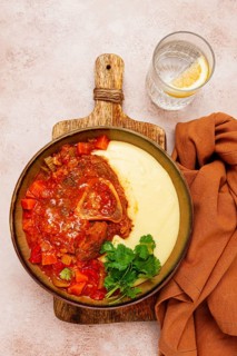 Ossobuco, stewed meat knuckle on the bone, with mashed potatoes, and oats and spices, homemade, no
