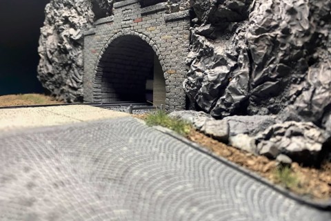 Modelling diorama: Detailed view of tunnel portal, rocks, road and tracks, Haan, North