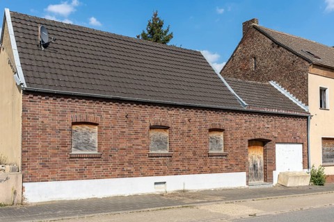 Brick house with barricaded windows and garage door, Manheim, North Rhine-Westphalia, Germany