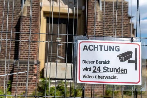 Warning sign Video surveillance in front of church behind fence, Manheim, North Rhine-Westphalia,