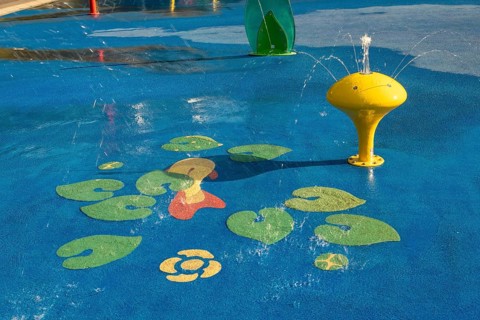 Yellow water play equipment with water lily motif, green belt, Cologne