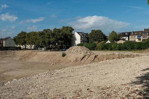 Excavation pit with houses in the background, Ehrenfeld, Cologne, North Rhine-Westphalia, Germany