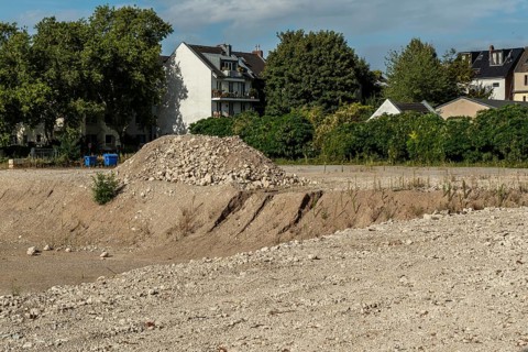 Extensive excavation pit with pile of stones, Ehrenfeld, Cologne, North Rhine-Westphalia, Germany