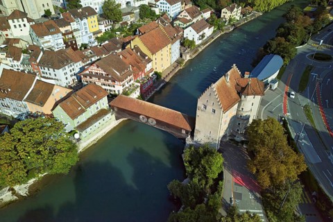 View of the old town with the river Limmat and the covered wooden bridge with the