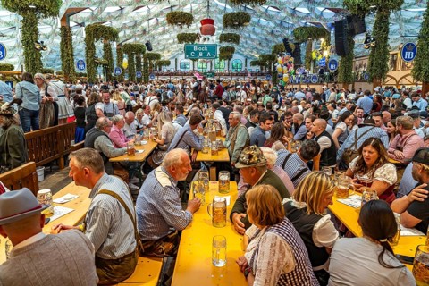 Visitors in the Hofbräu marquee at the Oktoberfest 2024 in Munich, Bavaria, Germany
