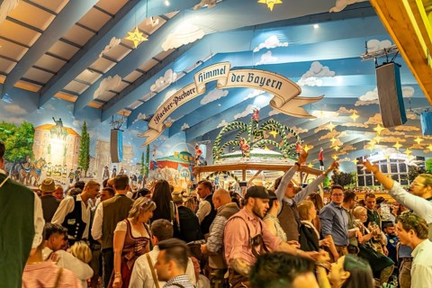 Visitors in the Hacker Pschorr marquee at the Oktoberfest 2024 in Munich, Bavaria, Germany