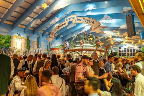 Visitors in the Hacker Pschorr marquee at the Oktoberfest 2024 in Munich, Bavaria, Germany