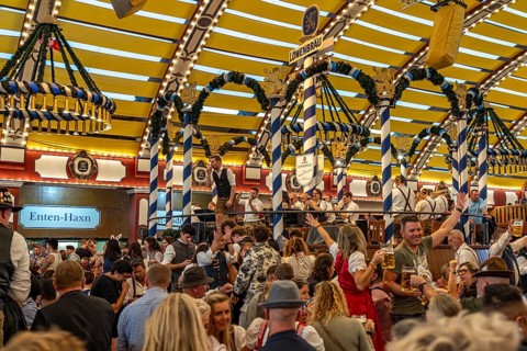 Visitors and band in the Löwenbräu marquee at the Oktoberfest 2024 in Munich, Bavaria, Germany