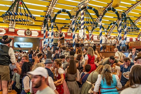 Visitors and band in the Löwenbräu marquee at the Oktoberfest 2024 in Munich, Bavaria, Germany