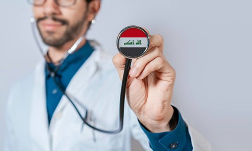 Doctor holding stethoscope with Iraq flag. Iraq health and care concept, Iraq flag on stethoscope