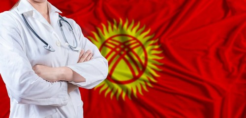 Doctor with crossed arms on Kyrgyzstan flag. Kyrgyzstan health and care concept. Female doctor on