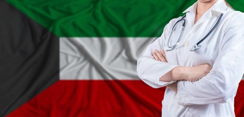 Doctor with crossed arms on Kuwait flag. Kuwait health and care concept. Female doctor on Kuwait